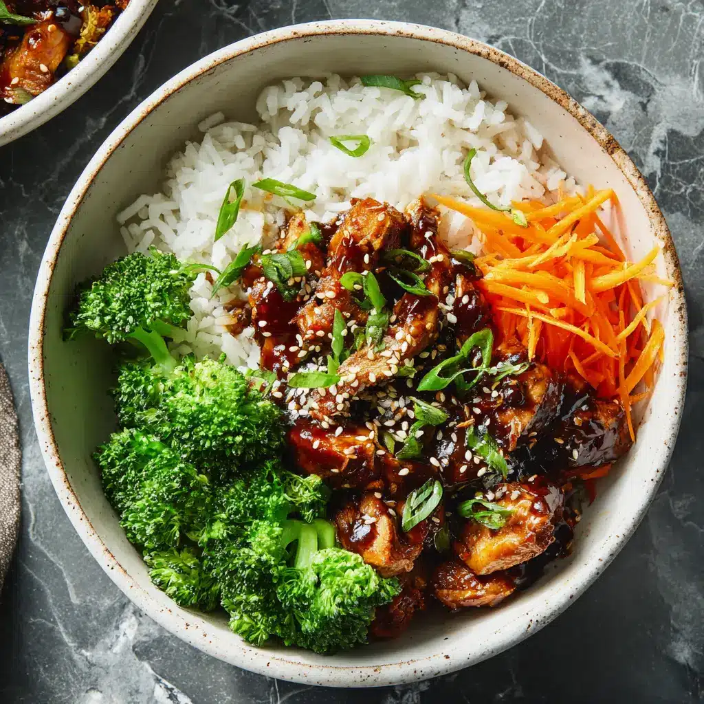 A close-up shot showing the glossy, thick homemade teriyaki sauce coating pieces of chicken in a bowl.