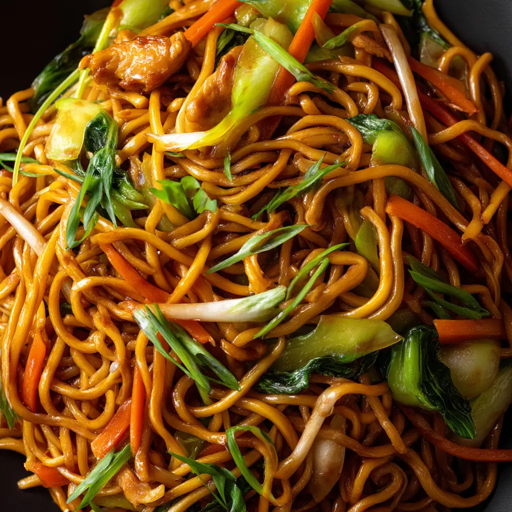 A detailed close-up of the finished chow mein, showcasing the crispy texture of the noodles coated in a savory brown sauce.