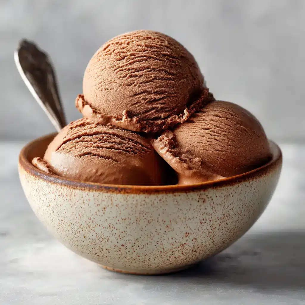 Coffee Gelato Recipe (Authentic & Creamy) 2 A close-up of three perfect scoops of rich, brown espresso gelato in a chilled glass bowl.
