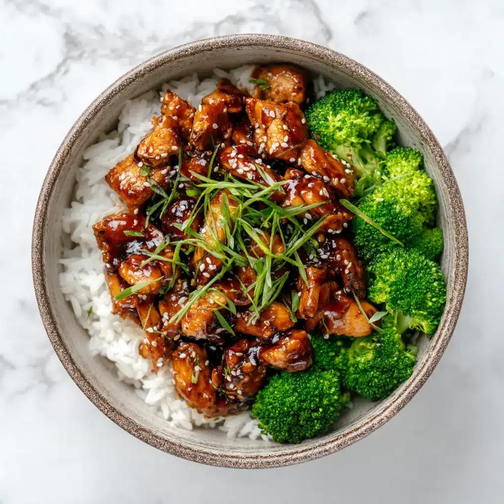 Teriyaki Chicken Bowl: Better Than Takeout in 30 Minutes 1 A close-up shot of the juicy, glazed chicken in the teriyaki chicken bowl, highlighting the texture of the homemade sauce.