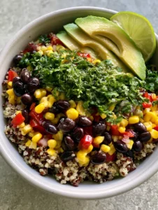 Close-up of fluffy red and white quinoa mixed with black beans and corn. (Quinoa Black Bean Salad)