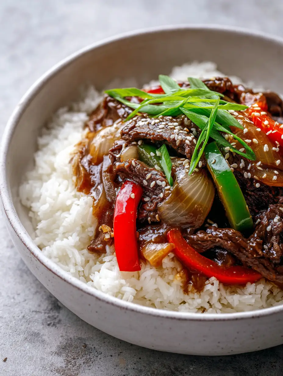 A smartphone photo of Slow Cooker Pepper Steak showing the velvety sauce and vibrant bell peppers in a white bowl.